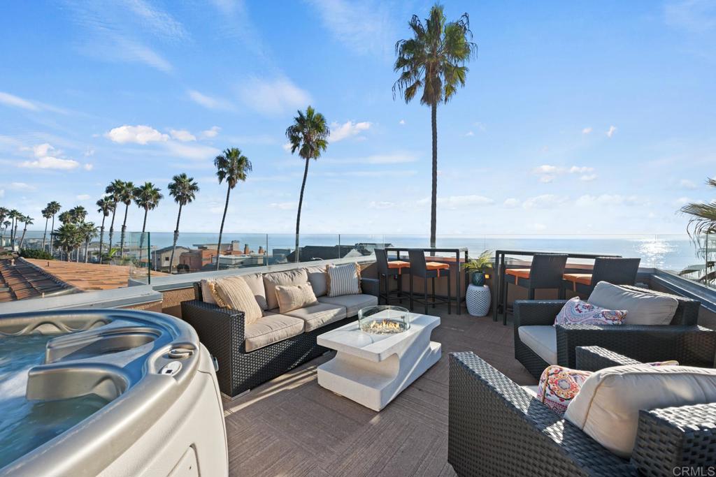 a view of roof deck with couches and potted plants