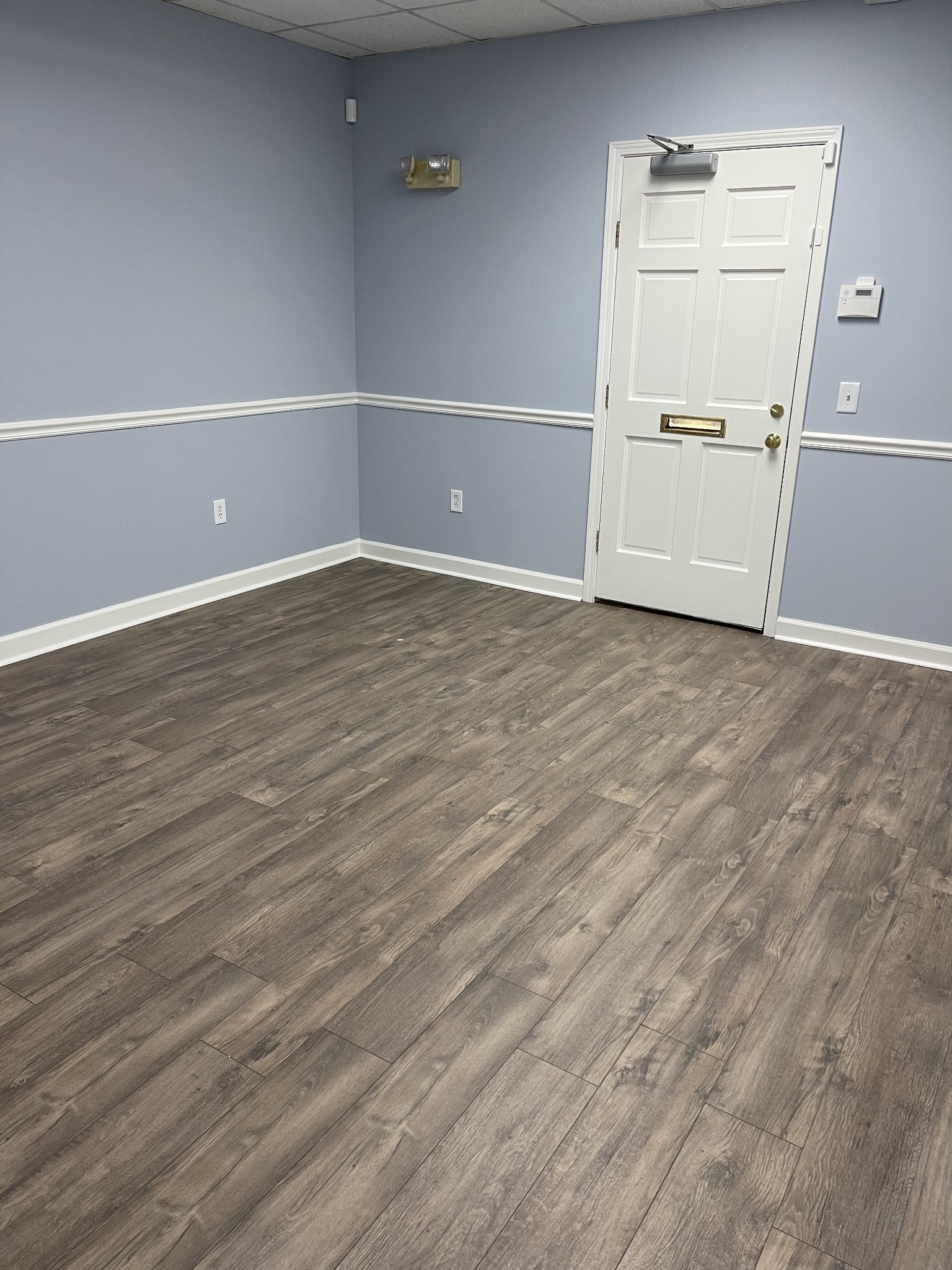 a view of a room with wooden floor