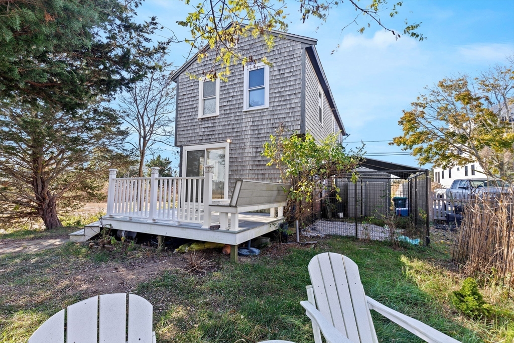 a view of a house with backyard and sitting area