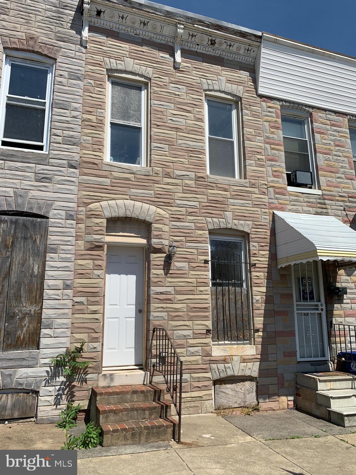 a front view of a house with stairs