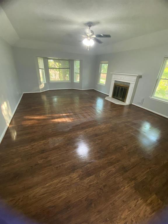 a view of empty room with window and fireplace