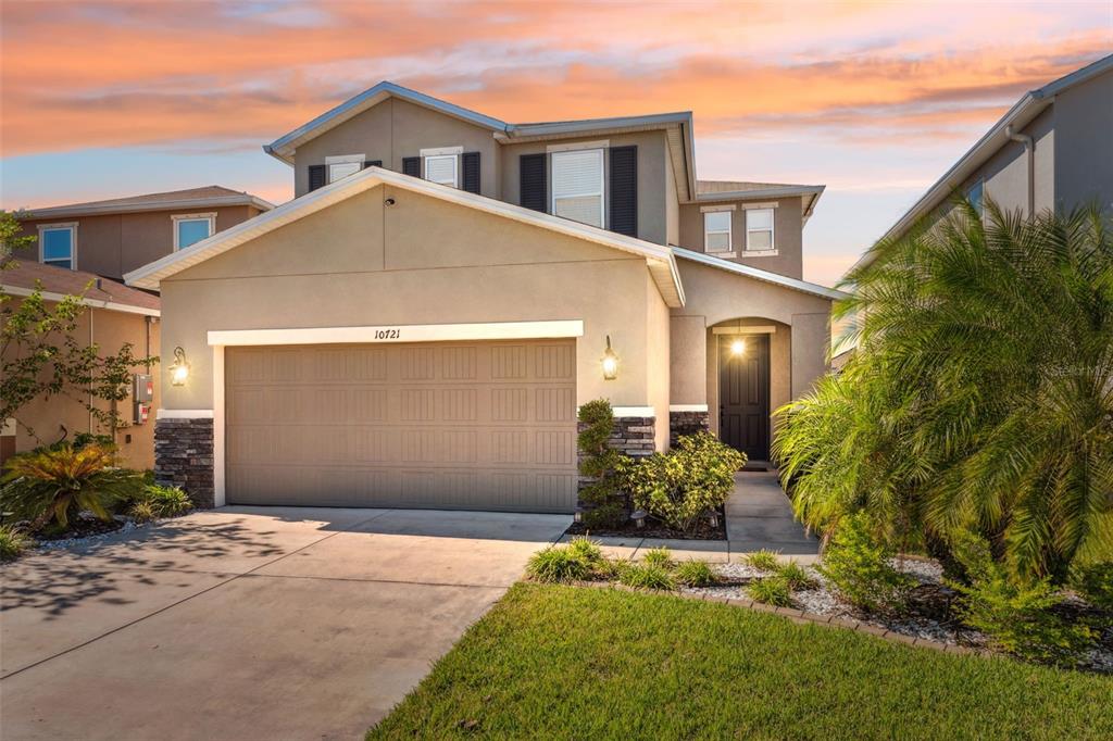 a front view of a house with a yard and garage