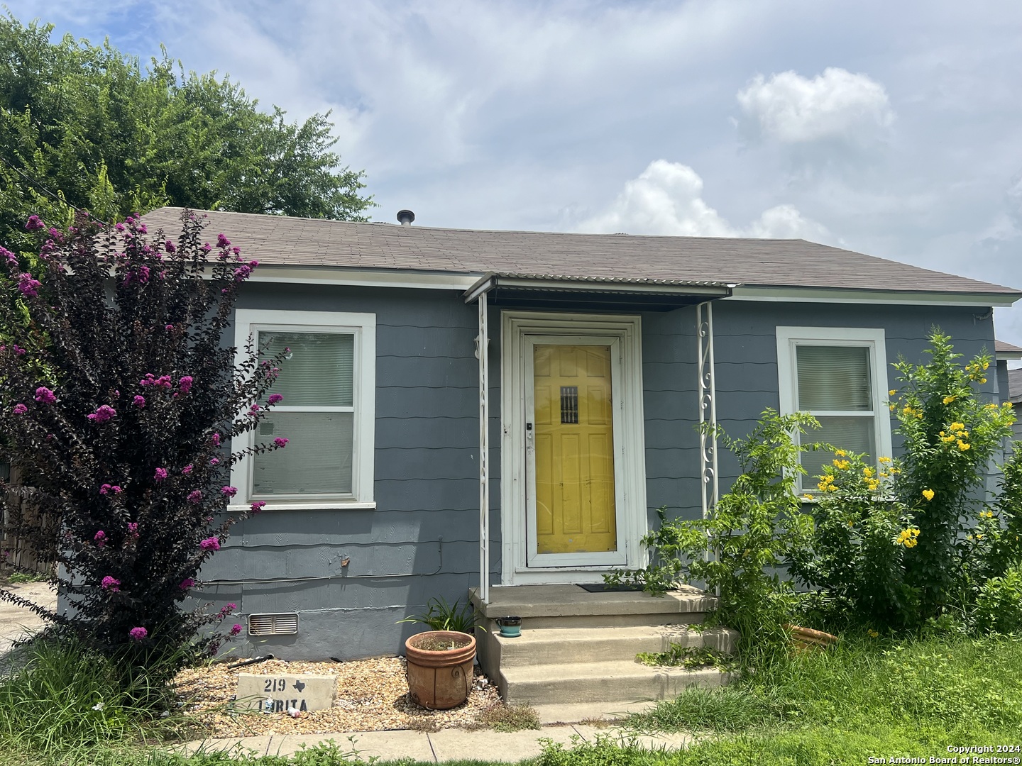 a front view of a house with garden