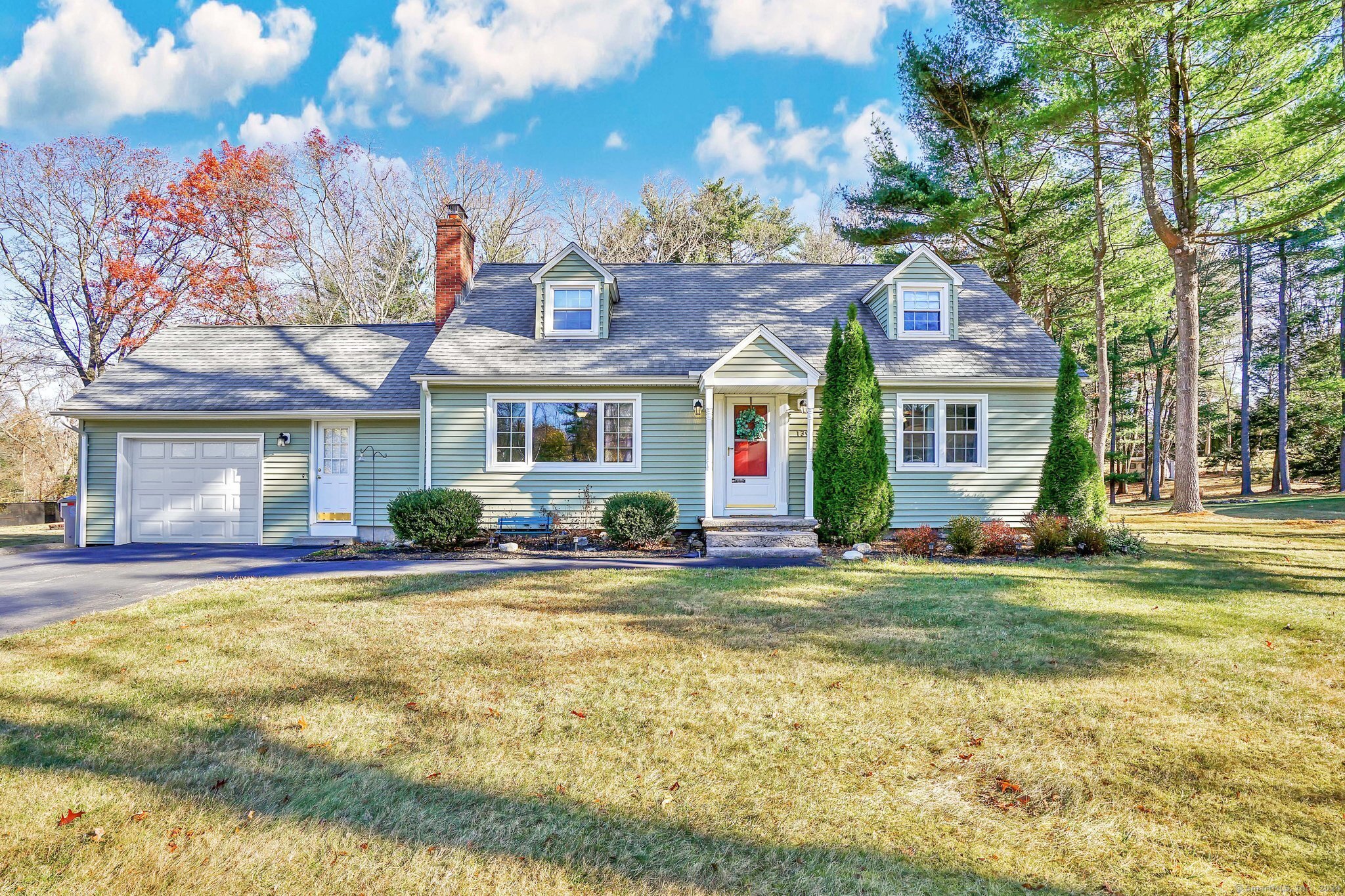 a view of a house with a patio and a yard