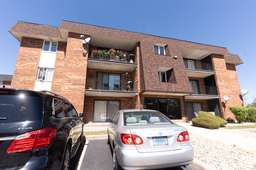 a view of building with car parked