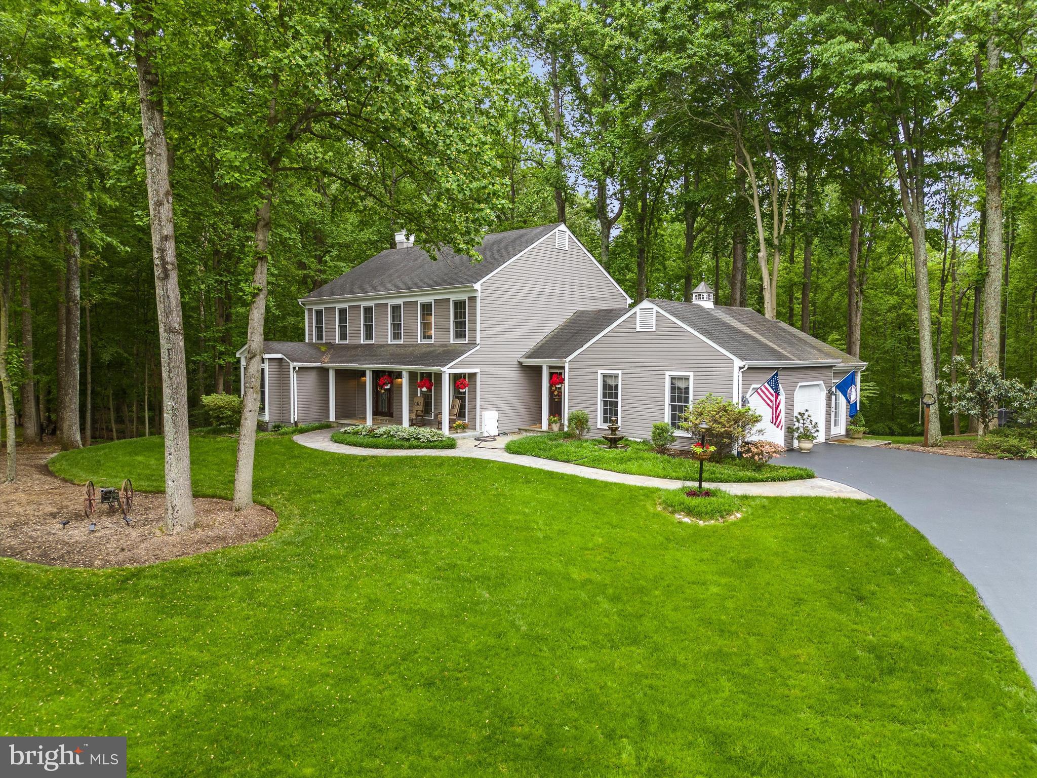 a front view of a house with yard and green space