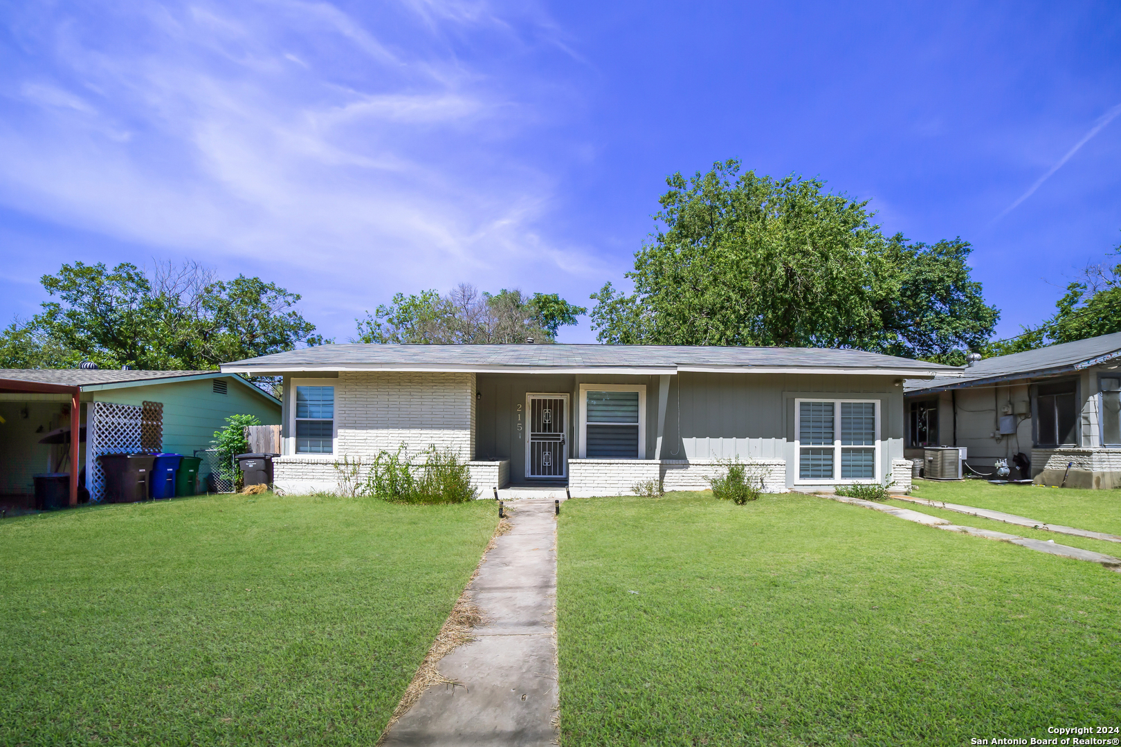 a front view of house with yard and green space