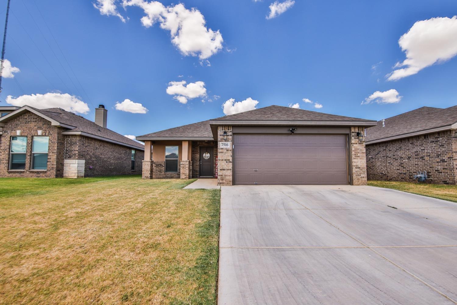 a view of a house with a yard and garage