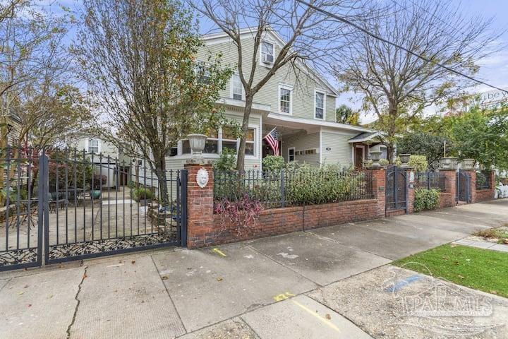 a front view of a house with a garden