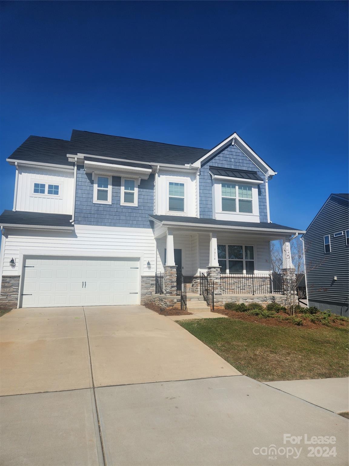 a front view of a house with yard and seating space