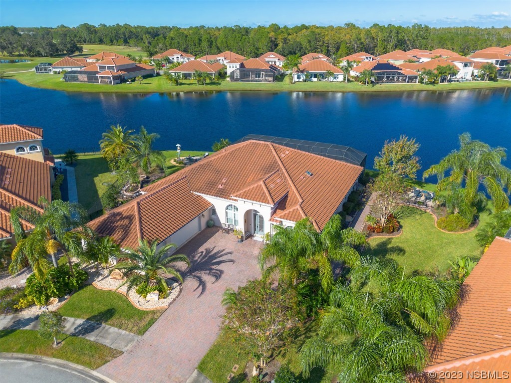 an aerial view of a houses with a lake view