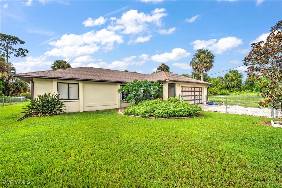 a view of a house with a backyard