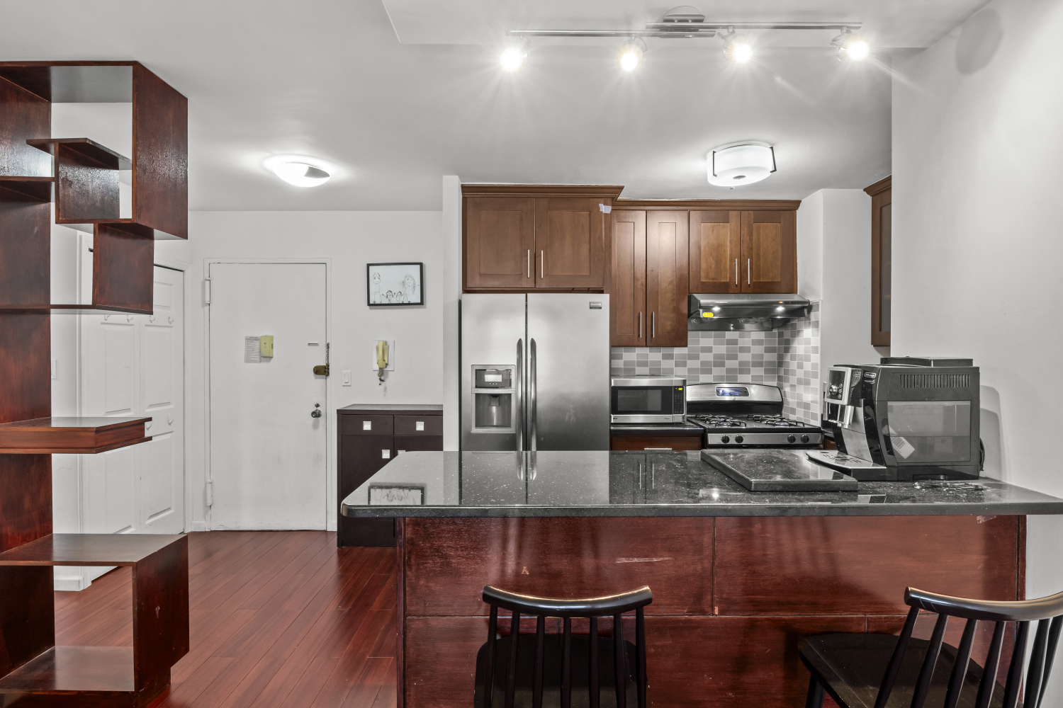 a kitchen with stainless steel appliances granite countertop a sink counter space and cabinets