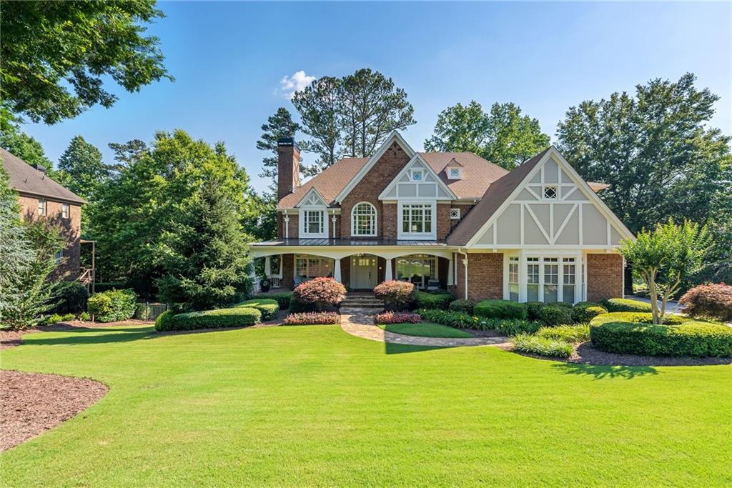 a front view of a house with swimming pool and porch