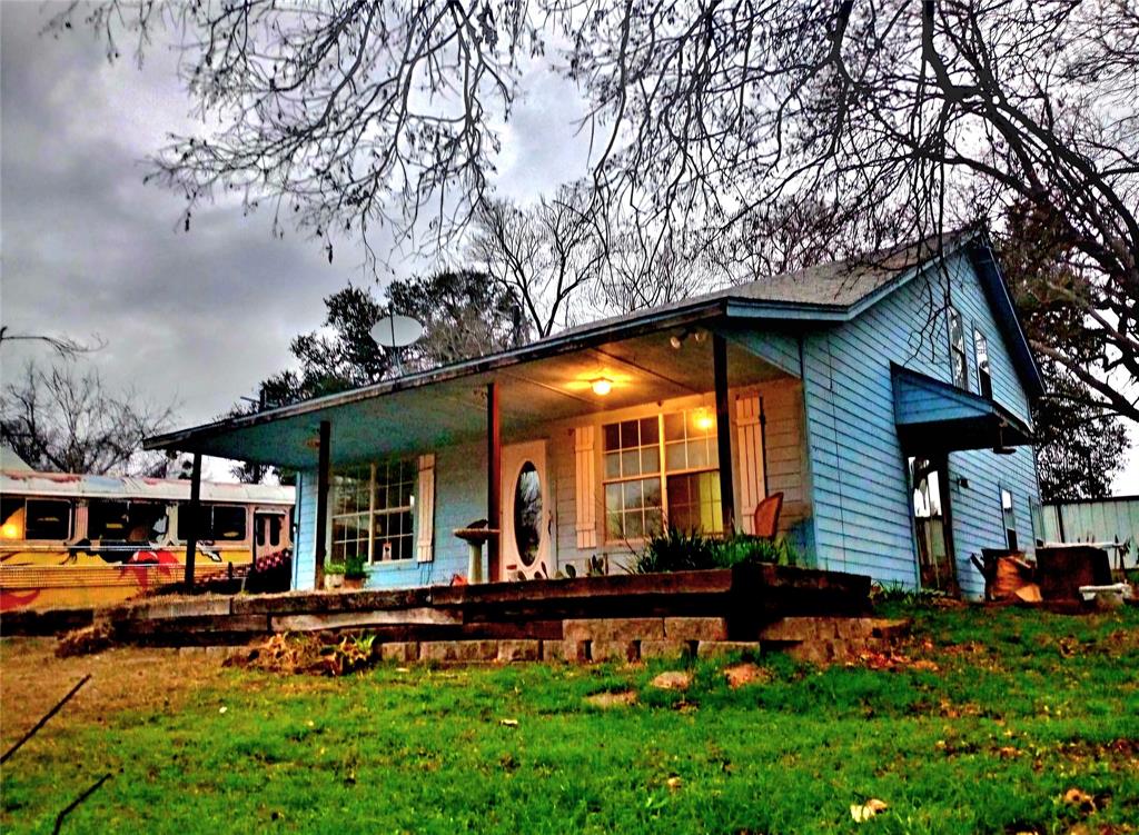 a front view of a house with a garden and plants