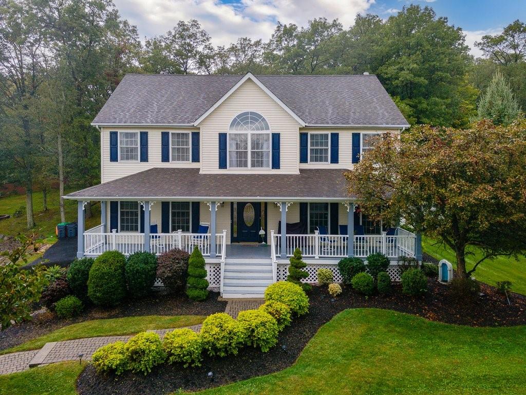 View of front of home with a front lawn and covered porch