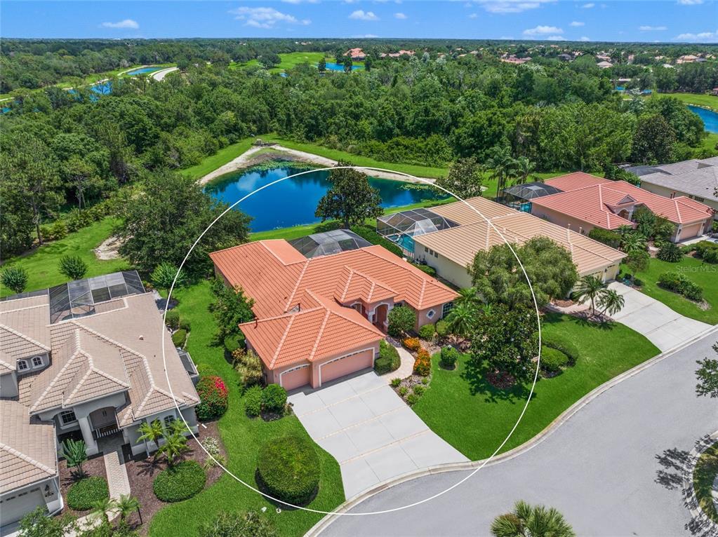 an aerial view of a house with garden space and street view