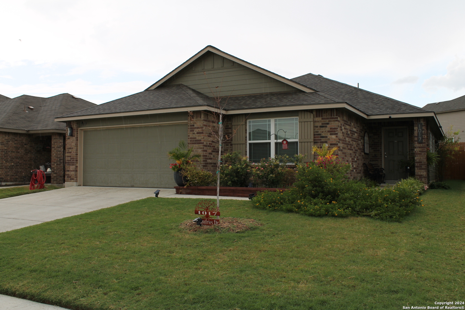 a front view of a house with a yard and garage