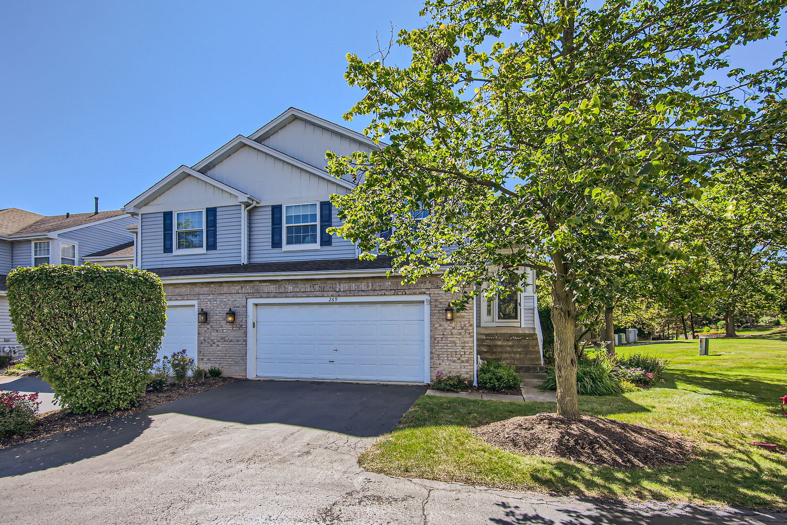 a front view of a house with a yard and garage