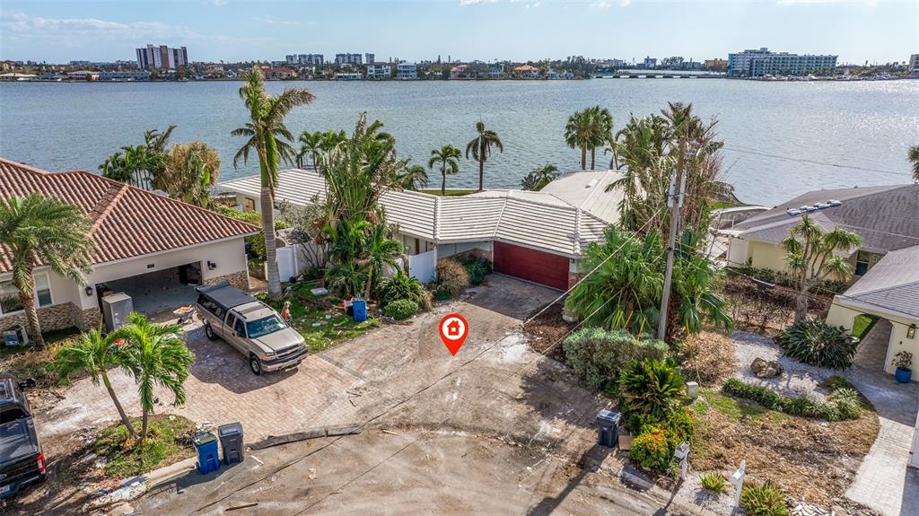 a aerial view of a house with garden space and a lake view