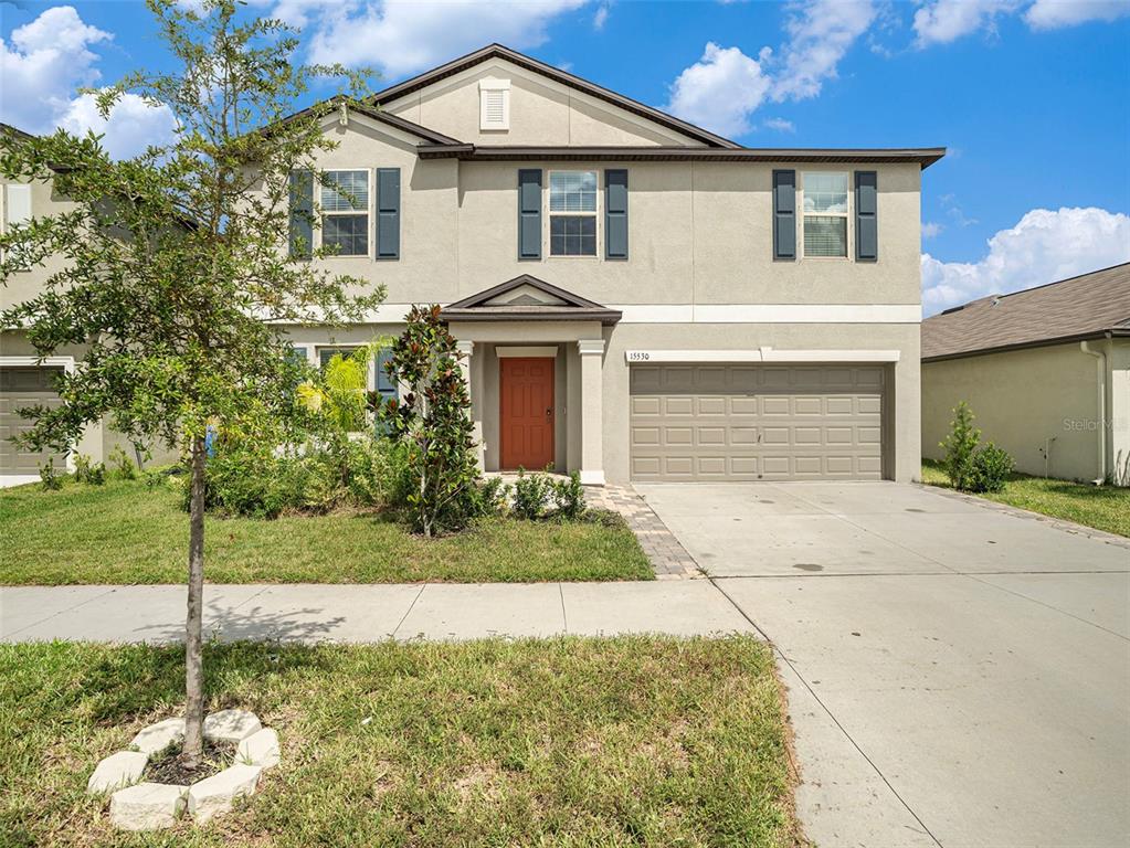 a front view of a house with a yard