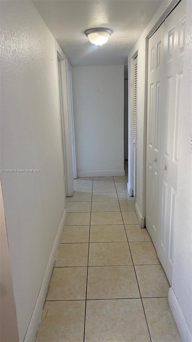 a view of hallway with a window and brick walls