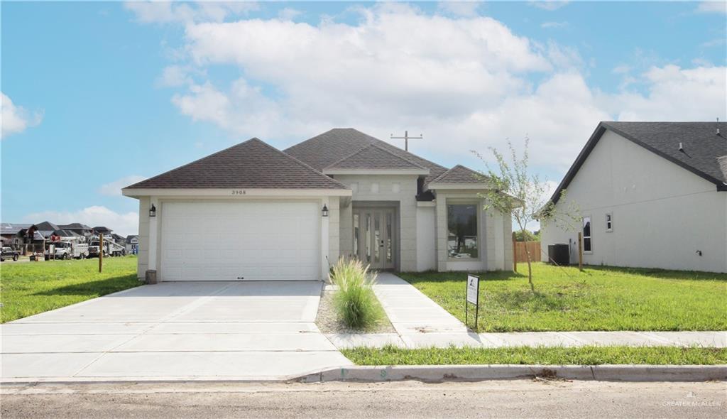 a view of a house with a yard and fence