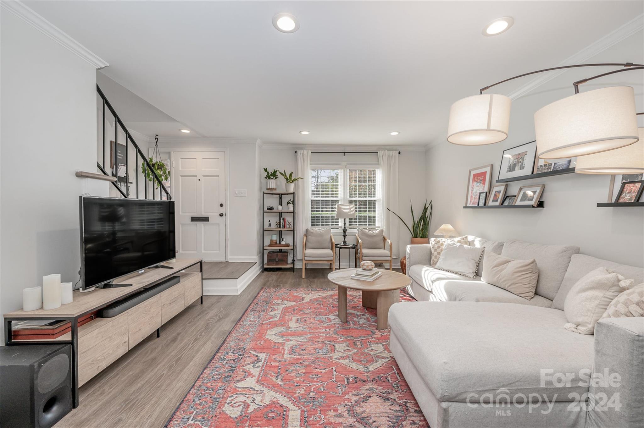 a living room with furniture and a flat screen tv