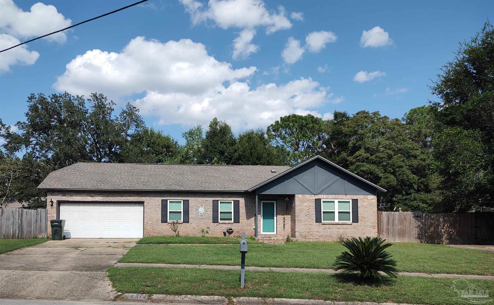 a view of house with a yard