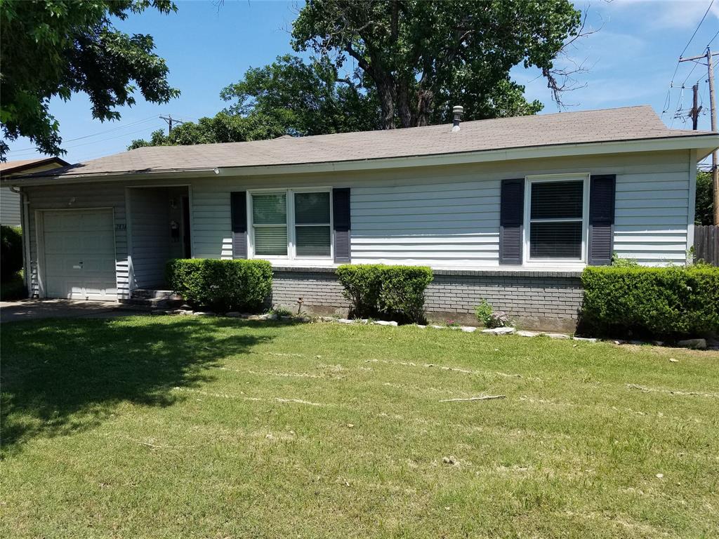 a front view of a house with a garden and plants