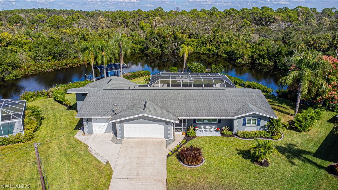 an aerial view of a house with swimming pool and big yard