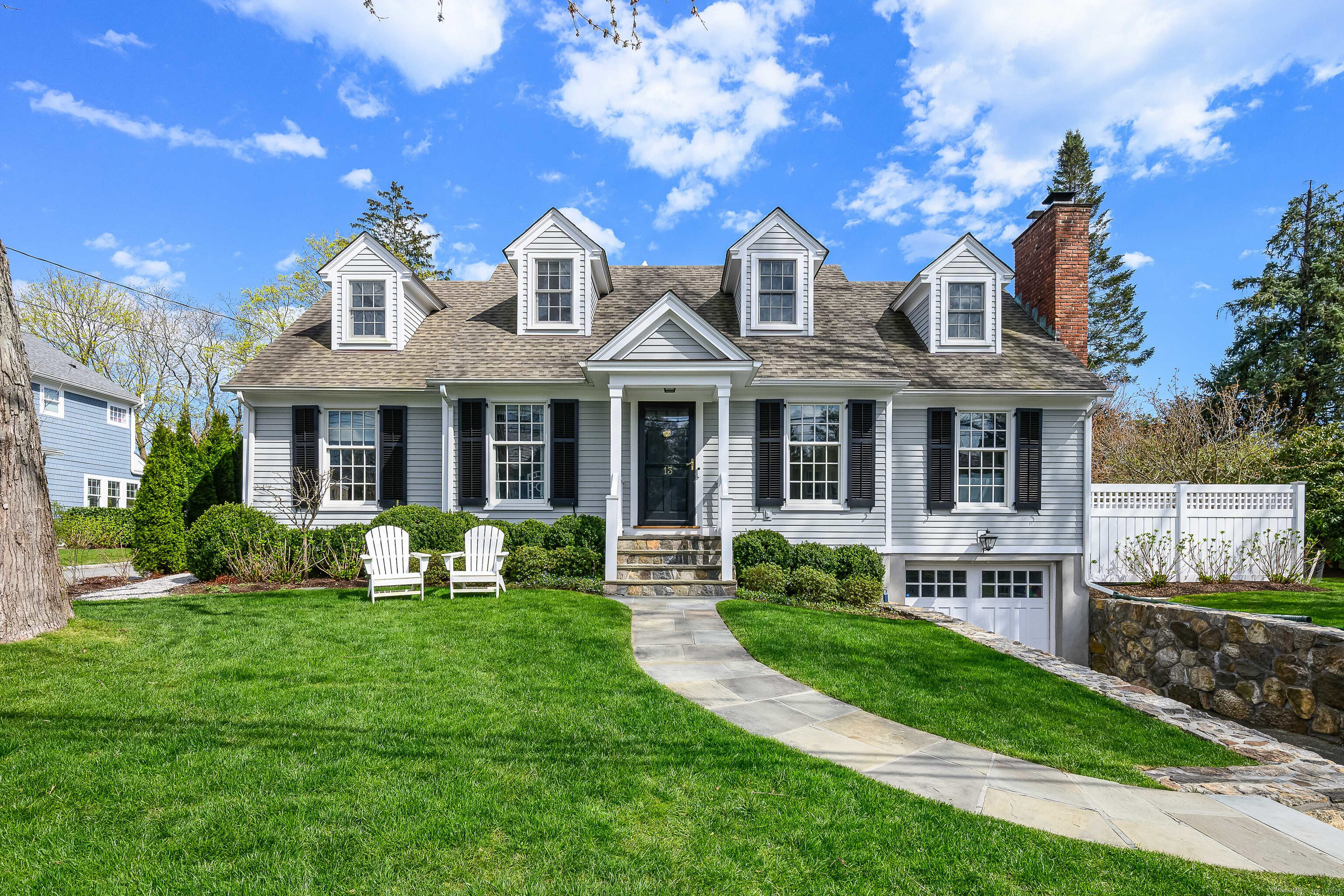 a front view of a house with garden and porch