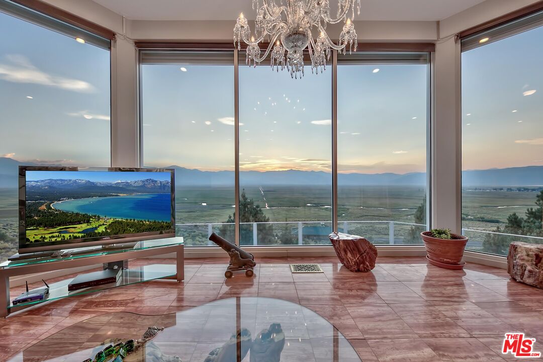 a living room filled with furniture and a floor to ceiling window