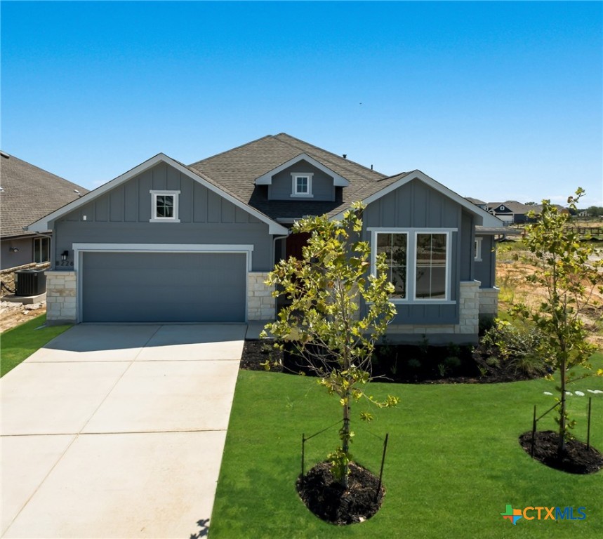 a front view of a house with a garden