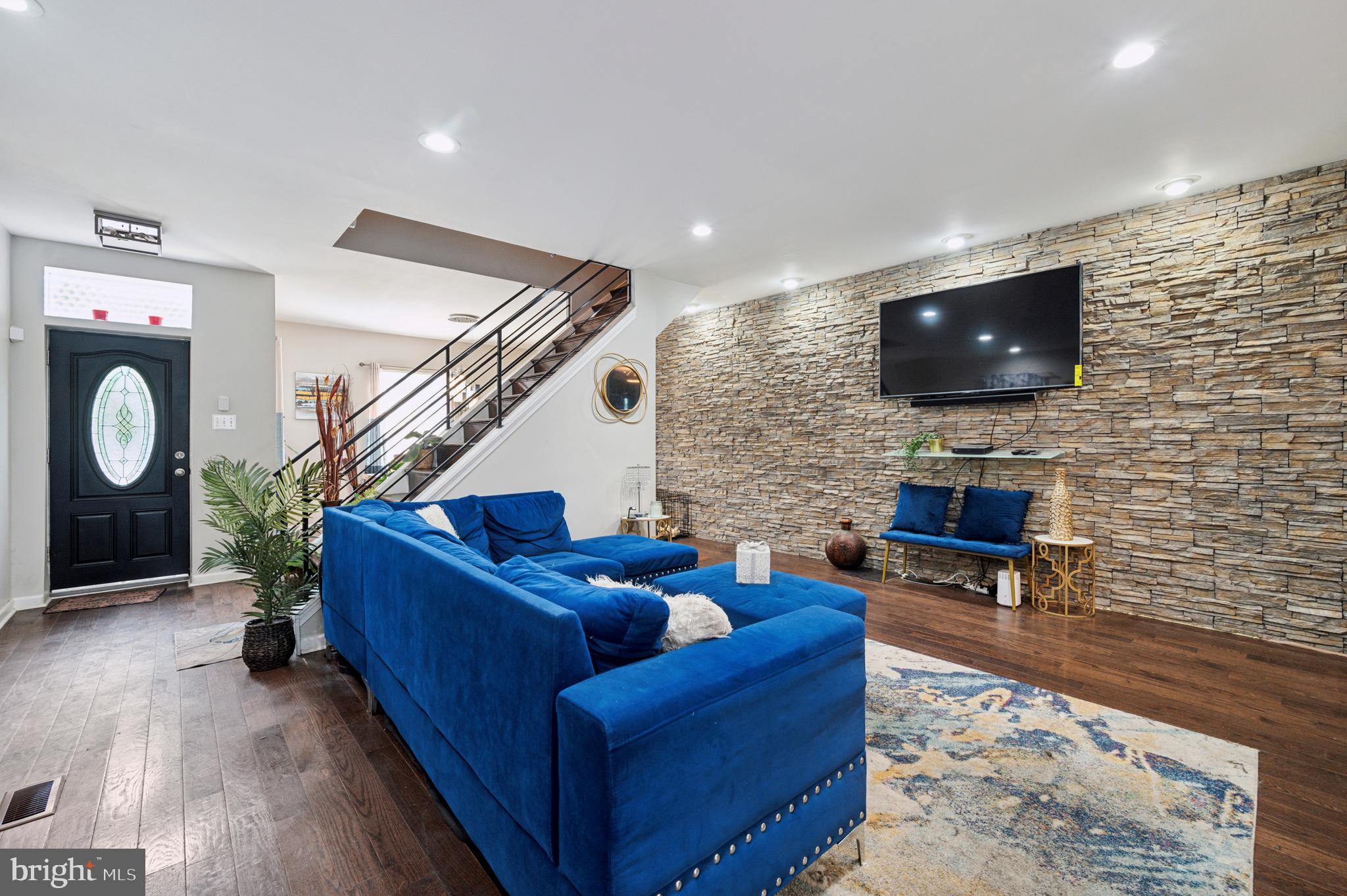 a living room with furniture and a flat screen tv