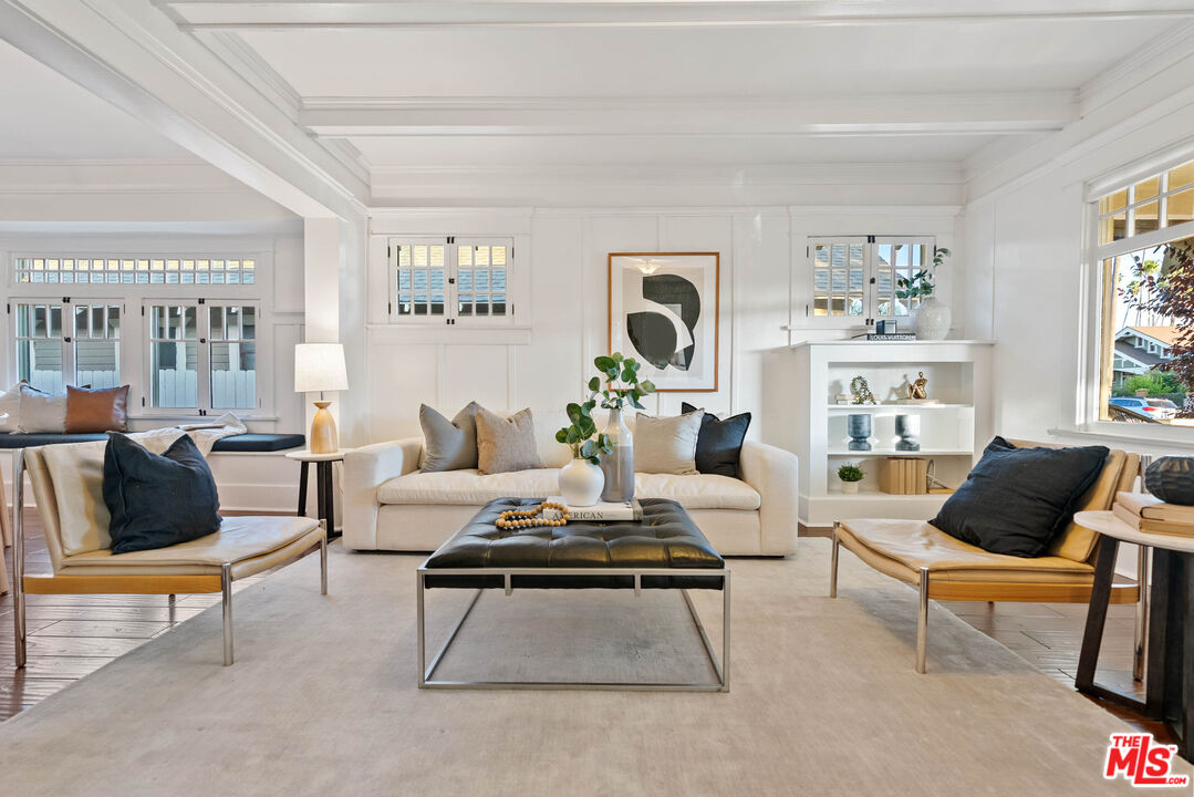 a living room with furniture and a potted plant on table