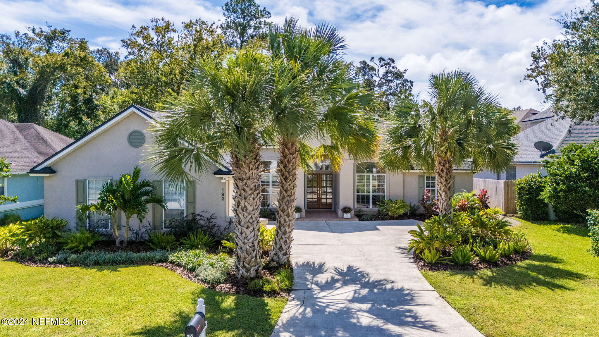 a front view of a house with a yard and outdoor seating