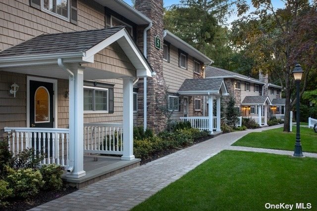 a front view of a house with a yard porch and outdoor seating