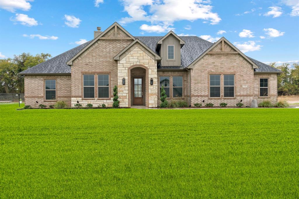 a front view of house with yard and green space