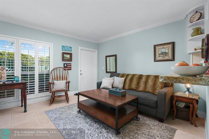 a living room with furniture a rug and a large window