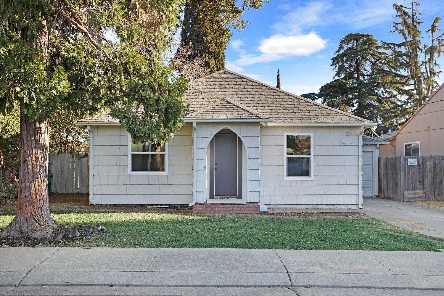 a front view of a house with a garden