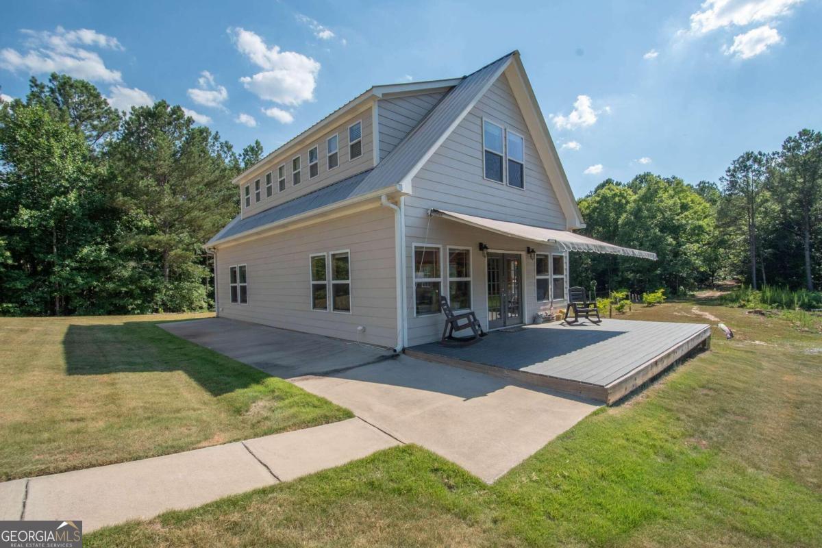 a front view of a house with yard and green space