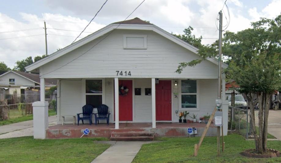 a front view of house with yard and outdoor seating