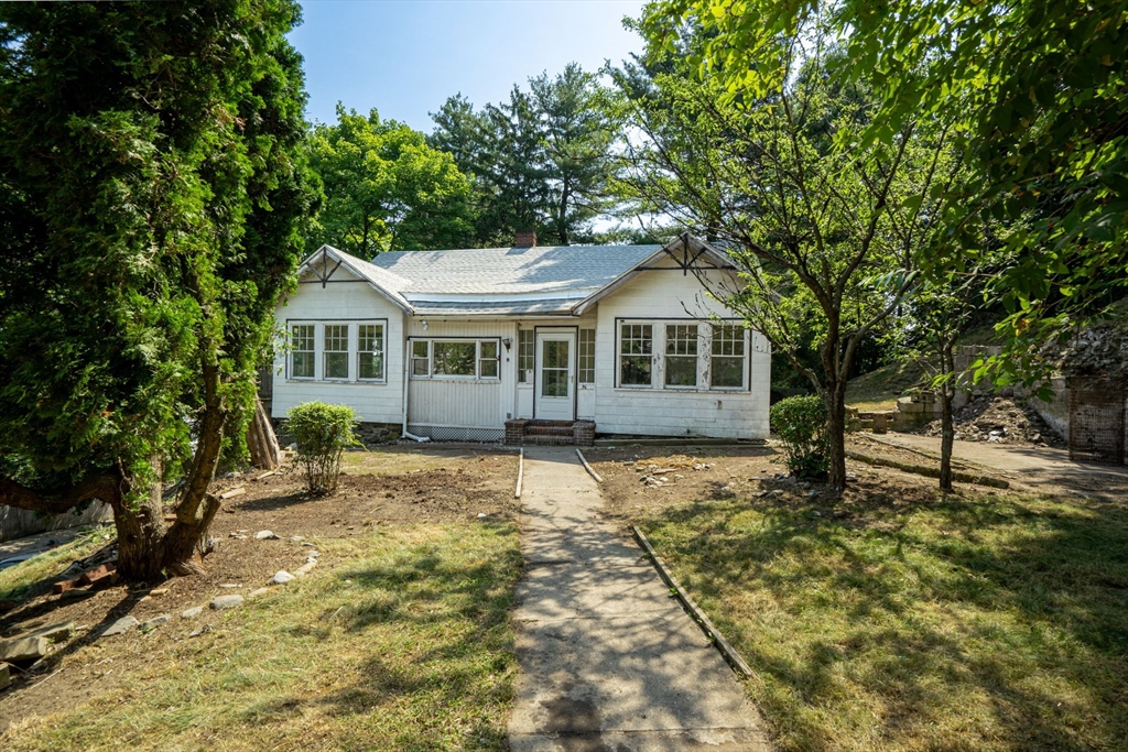 a front view of a house with a garden