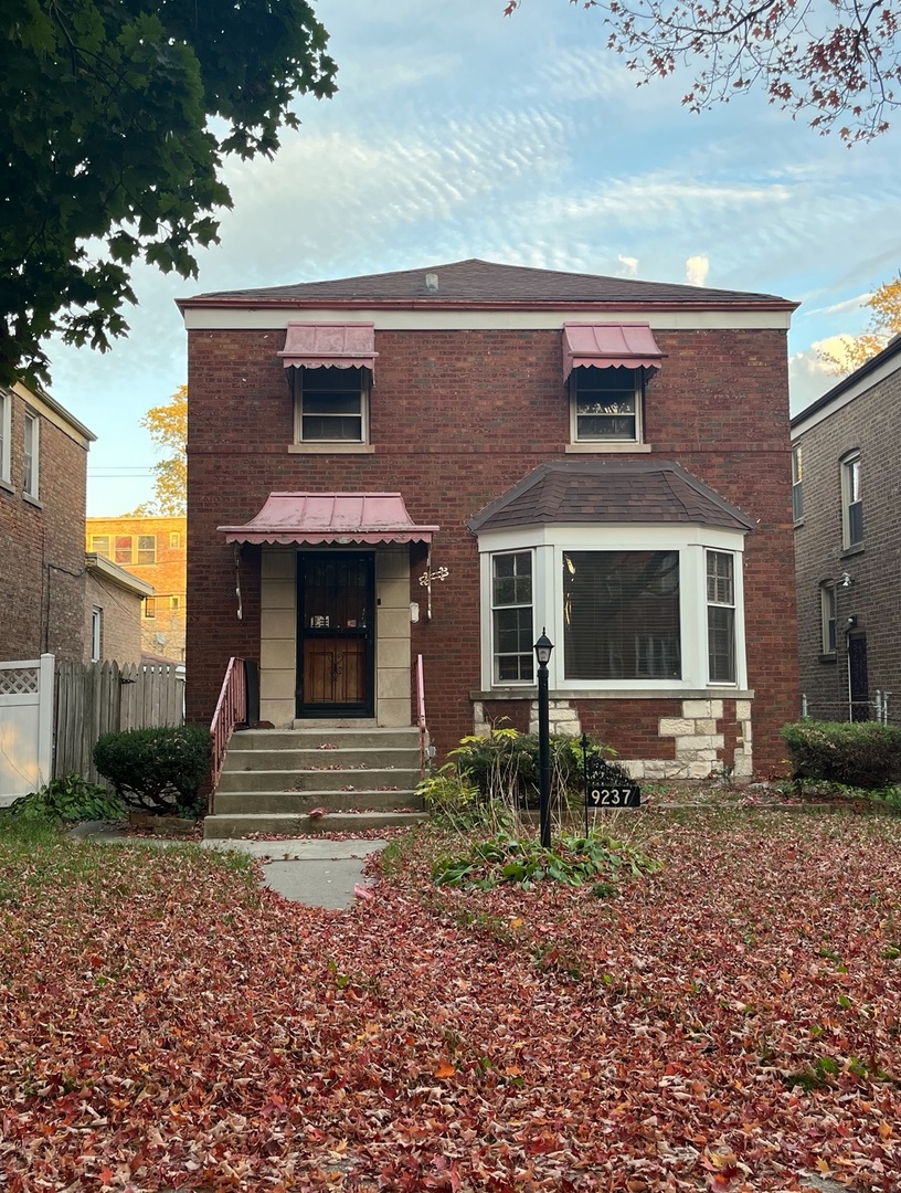 a front view of a house with garden and patio