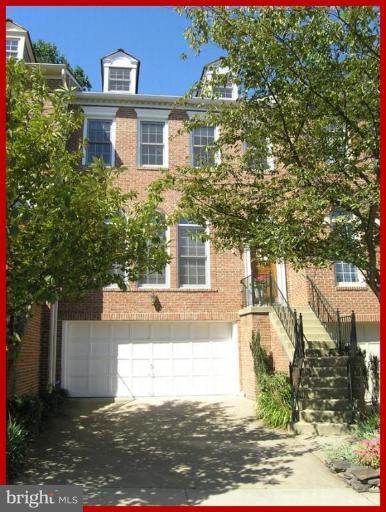 a view of a brick house next to a yard