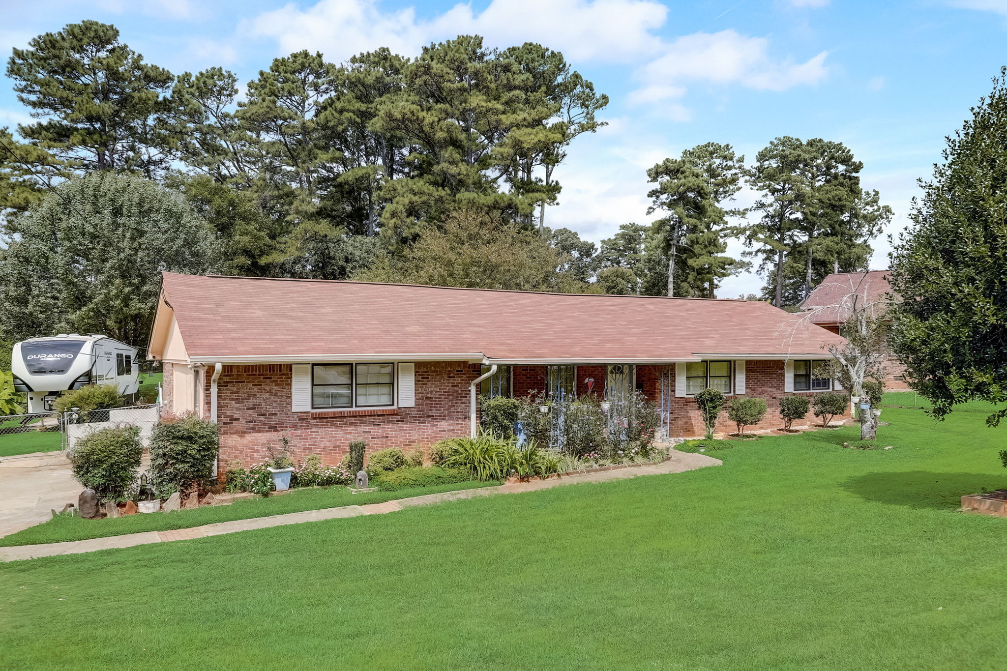 a front view of a house with a garden