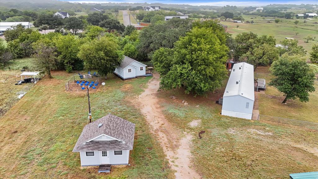 an aerial view of a house with a garden and lake view