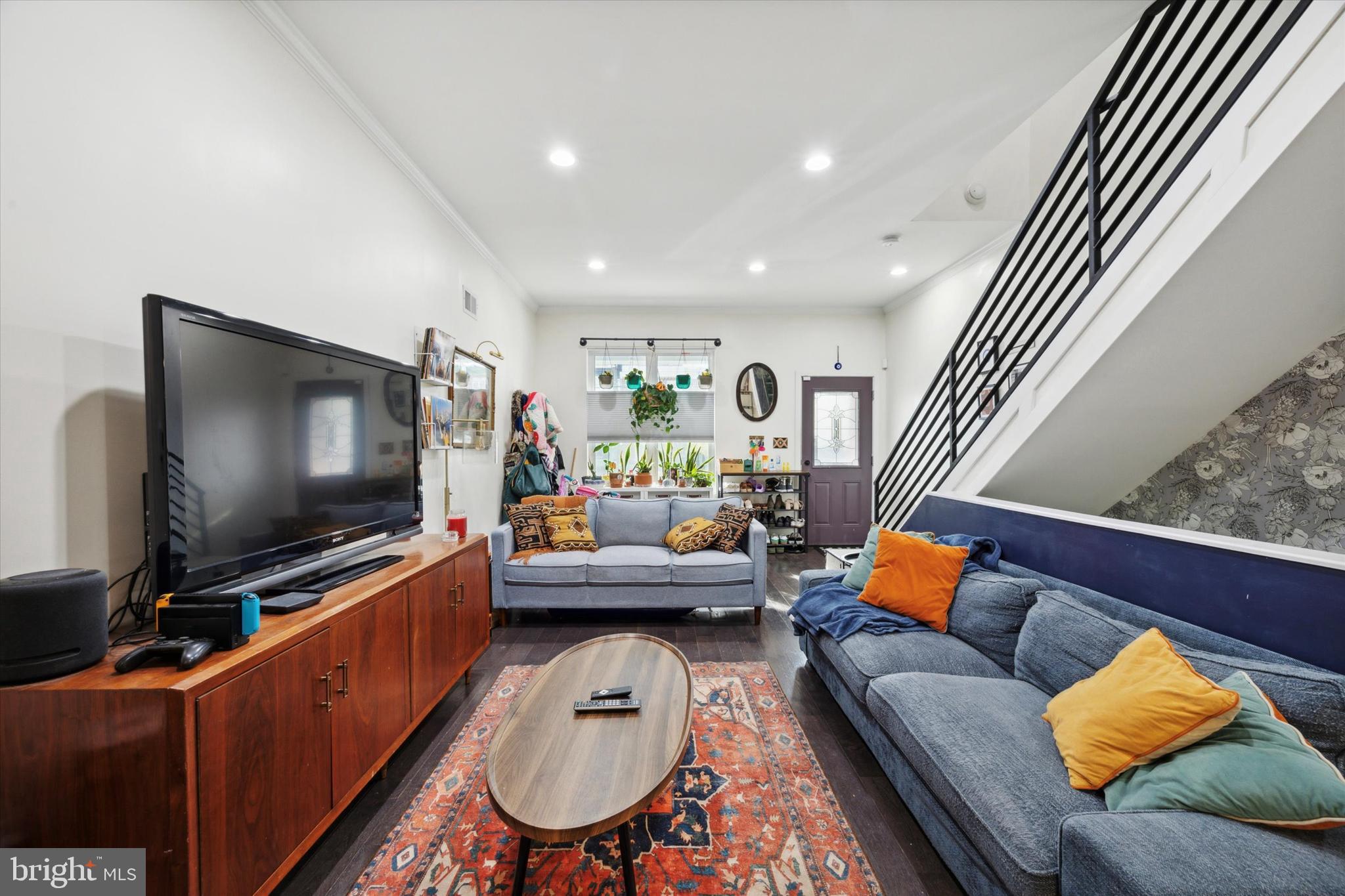 a living room with furniture and a flat screen tv