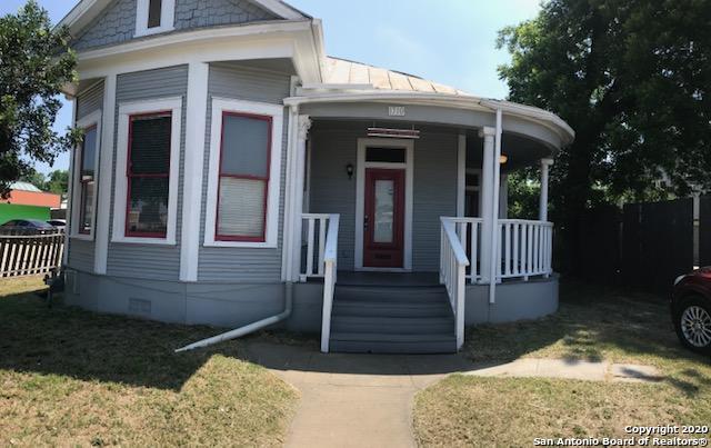 a view of a house with a yard in front of it